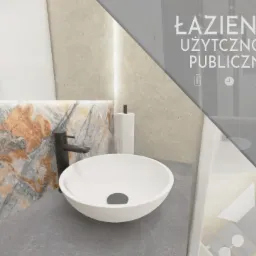 Wizualizacja umywalki nablatowej w łazience publicznej z blatem z szarego kamienia i ścianą wykończoną płytkami imitującymi marmur z pomarańczowymi żyłkami, z widocznym logo projektanta w rogu.