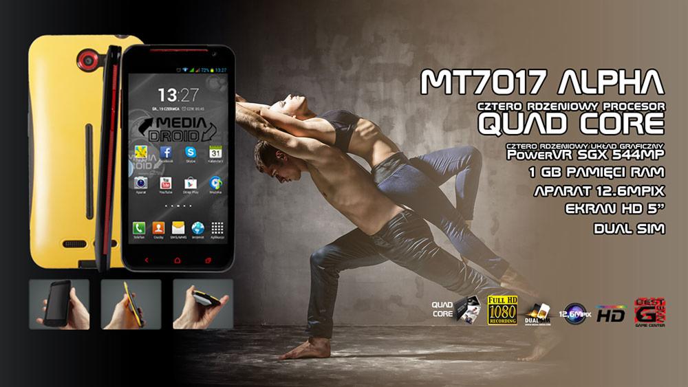 Żółto-czarny smartfon MT7017 Alpha z ekranem pokazującym aplikacje, na tle pary wykonującej akrobacje, z informacjami o specyfikacji techniczej: czterordzeniowy procesor, 1GB RAM, aparat 12.6MPIX...