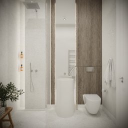 emwe studio architektury - Minimalistyczna łazienka w jasnych barwach z drewnianymi akcentami, obejmująca kabinę prysznicową typu walk-in, umywalkę wolnostojącą o cylindrycznym kształcie, wiszącą toaletę oraz dekoracyjną...