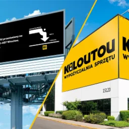 Billboard z informacją o przeniesieniu oddziału oraz żółty budynek z dużym logo wypożyczalni sprzętu, widok z zewnątrz w słoneczny dzień.