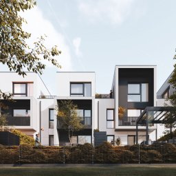 NUVIO Architects sp. z o.o - Nowoczesne, szeregowe domy z balkonami, otoczone zielenią i niskim żywopłotem. Minimalistyczna architektura z elementami czerni i bieli, widok z poziomu trawnika.