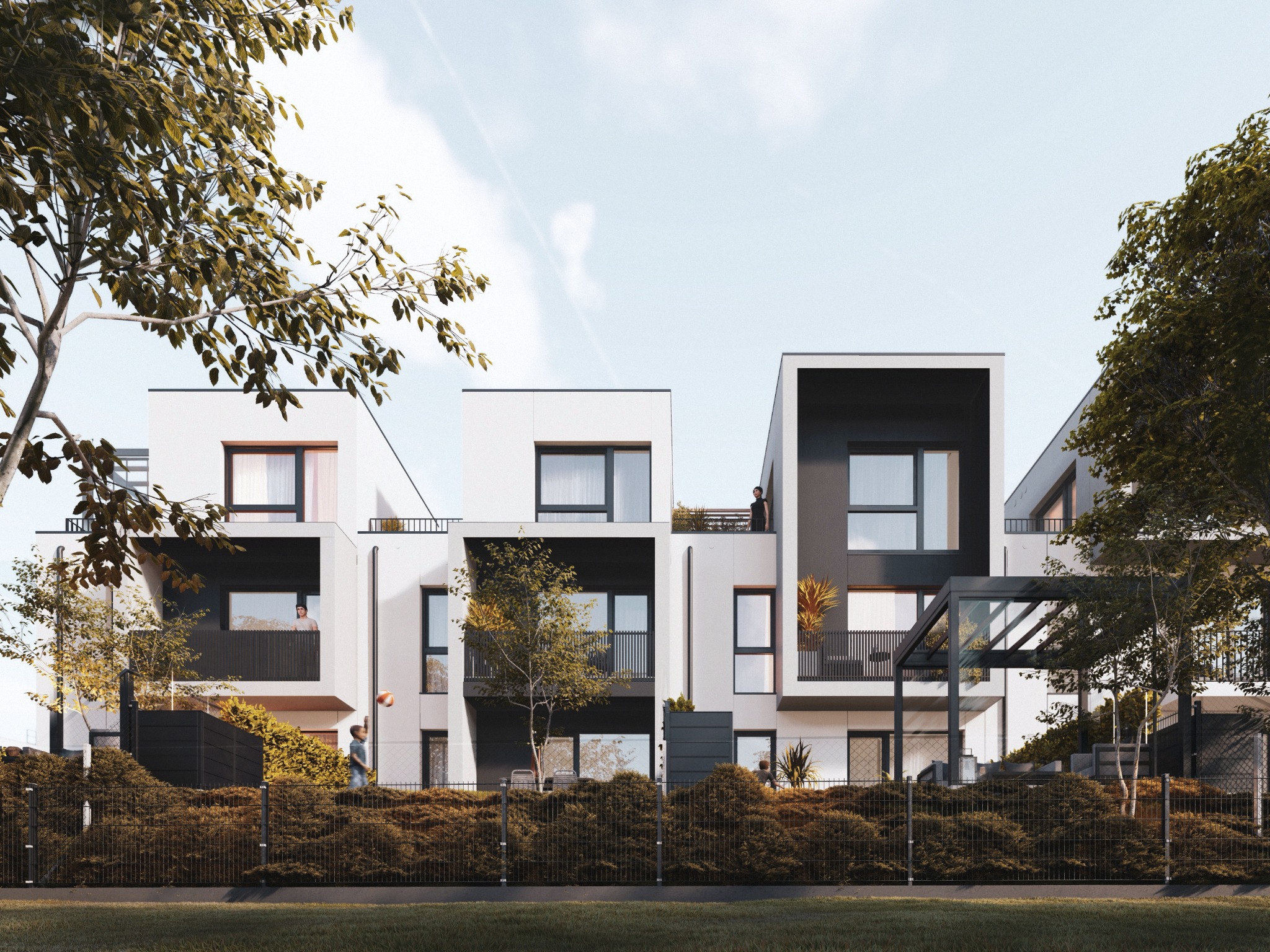 Nowoczesne, szeregowe domy z balkonami, otoczone zielenią i niskim żywopłotem. Minimalistyczna architektura z elementami czerni i bieli, widok z poziomu trawnika.