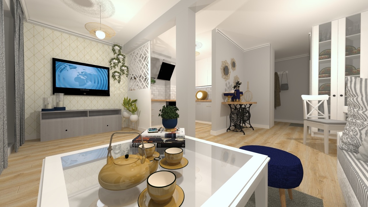 Wnętrze mieszkania z otwartą kuchnią, widok na salon z telewizorem, stolikiem kawowym z serwisem do herbaty i dekoracjami, oraz jadalnię z krzesłem i szafą.
