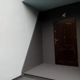 Świeżo pomalowane wnętrze klatki schodowej z ciemnobrązowymi drzwiami wejściowymi i szarą podłogą, widoczne przejście kolorów na ścianach i sufitach.