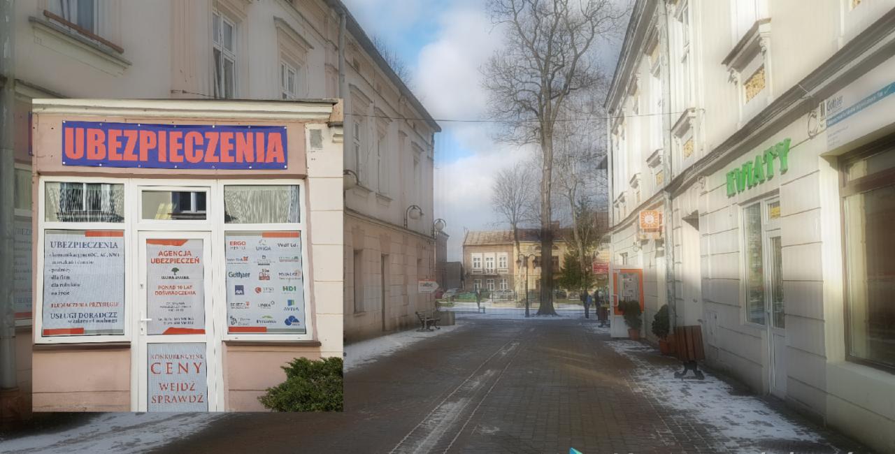 Fasada budynku z szyldem 'Ubezpieczenia' w małym miasteczku, widok na ulicę w zimowy dzień, obok kwiaciarnia.