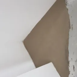 Świeżo wylana, jasnobrązowa masa na podłodze, przy styku ze ścianą, widoczne nierówności i ślady po narzędziach, surowy stan wykończenia.