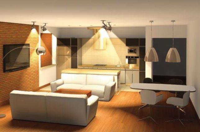 Wizualizacja przestronnego salonu z aneksem kuchennym, ukazująca białe sofy, drewnianą podłogę i ceglaną ścianę z telewizorem, oświetlonego reflektorami i wiszącymi lampami.