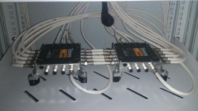 Dwa rozgałęźniki antenowe Televes połączone kablami koncentrycznymi w szafie rack.