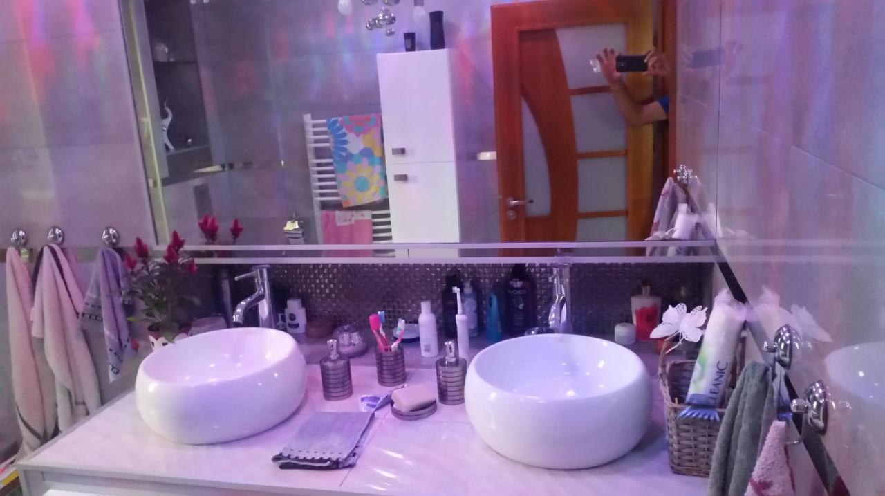 Umywalki nablatowe w nowoczesnej łazience w Slough, z widocznym odbiciem osoby robiącej zdjęcie telefonem w lustrze.