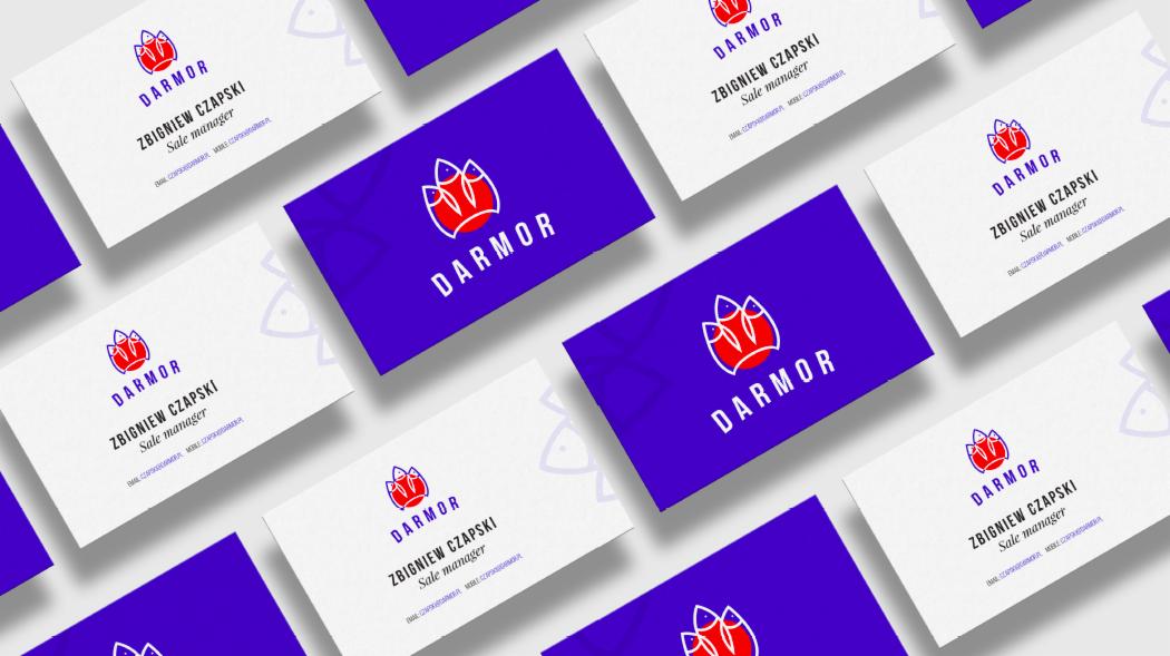 Układ wizytówek firmy DARMOR z logo przedstawiającym stylizowaną rybę i danymi kontaktowymi Zbigniewa Czapskiego, Sales Manager, na białym i fioletowym tle.