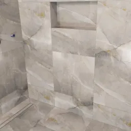 Wykończona łazienka z szarymi płytkami imitującymi marmur i wnęką w ścianie, widoczny odpływ liniowy w podłodze.