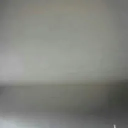 Wnętrze pokoju po nałożeniu gładzi gipsowej na ściany i sufit, widoczne niedoskonałości w wykończeniu pod światło.