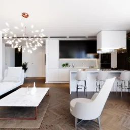 Jasne, przestronne wnętrze: salon z marmurowym stolikiem kawowym na miedzianych nóżkach, biała sofa, krzesło i kuchnia z wyspą barową, oświetlone dekoracyjną lampą w kolorze miedzi.