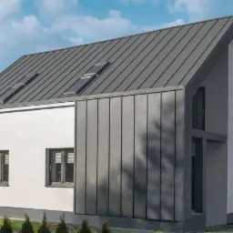 Nowoczesny dom jednorodzinny z szarą elewacją z paneli pionowych i dachem z widocznymi oknami dachowymi.