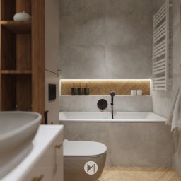Emkaprojket projektowanie wnętrz - Emilia Witkowska - Nowoczesna łazienka w odcieniach szarości i beżu z drewnianymi akcentami, umywalka nablatowa, bateria w kolorze czarnym, wanna z zabudową, dekoracyjna wnęka z oświetleniem i wzorem jodełki...