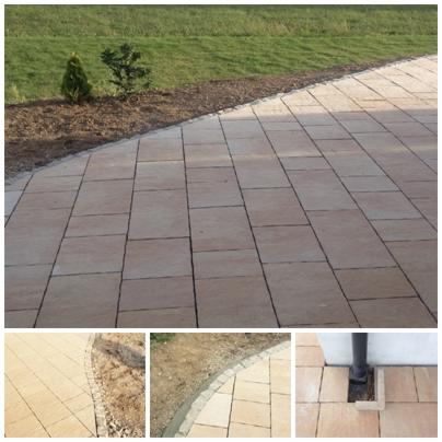 Beżowa kostka brukowa ułożona na podjeździe, obrzeże z kostki oddziela trawnik z młodymi drzewkami iglastymi.