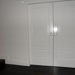 Drzwi dwuskrzydłowe białe przesuwne w kasecie.