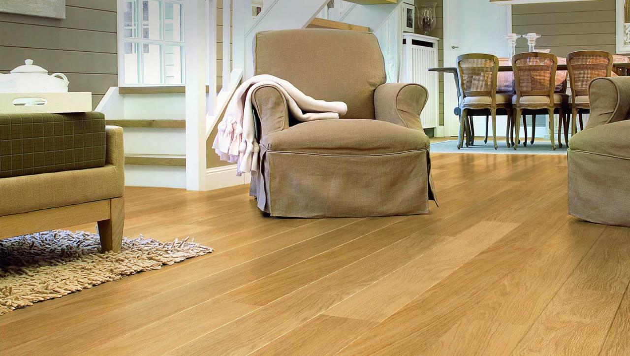 Jasna, drewniana podłoga w salonie w Raciborzu, z widocznymi dwoma fotelami w odcieniach beżu i elementami schodów w tle.