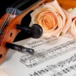 Skrzypce z partyturą 'Wedding March' i dwoma brzoskwiniowymi różami na czarnym tle.
