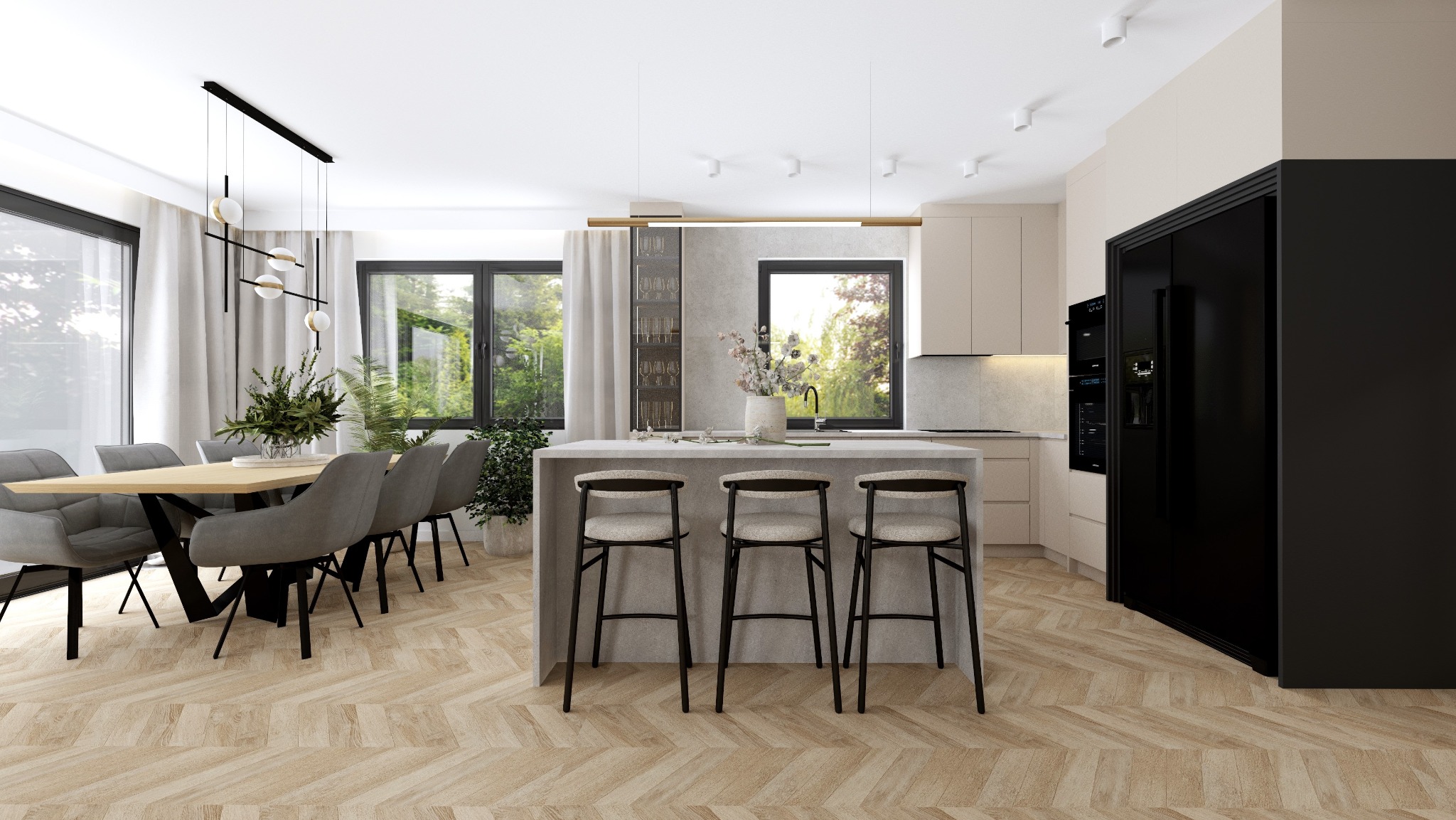Jasna kuchnia z wyspą i stołem jadalnym, parkiet w jodełkę, czarna lodówka, okna z widokiem na zieleń.