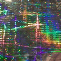 Holograficzna folia z powtarzającym się napisem 'ORIGINAL' i efektem tęczy, przeznaczona na naklejki, etykiety lub plomby.