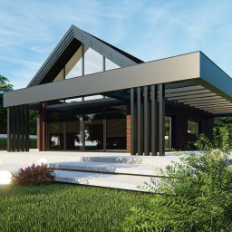 Pil-dom,Paweł Subotkiewicz - Nowoczesny dom murowany z ciemnej cegły z dużymi oknami, płaskim dachem i oświetlonym tarasem, otoczony zielenią.