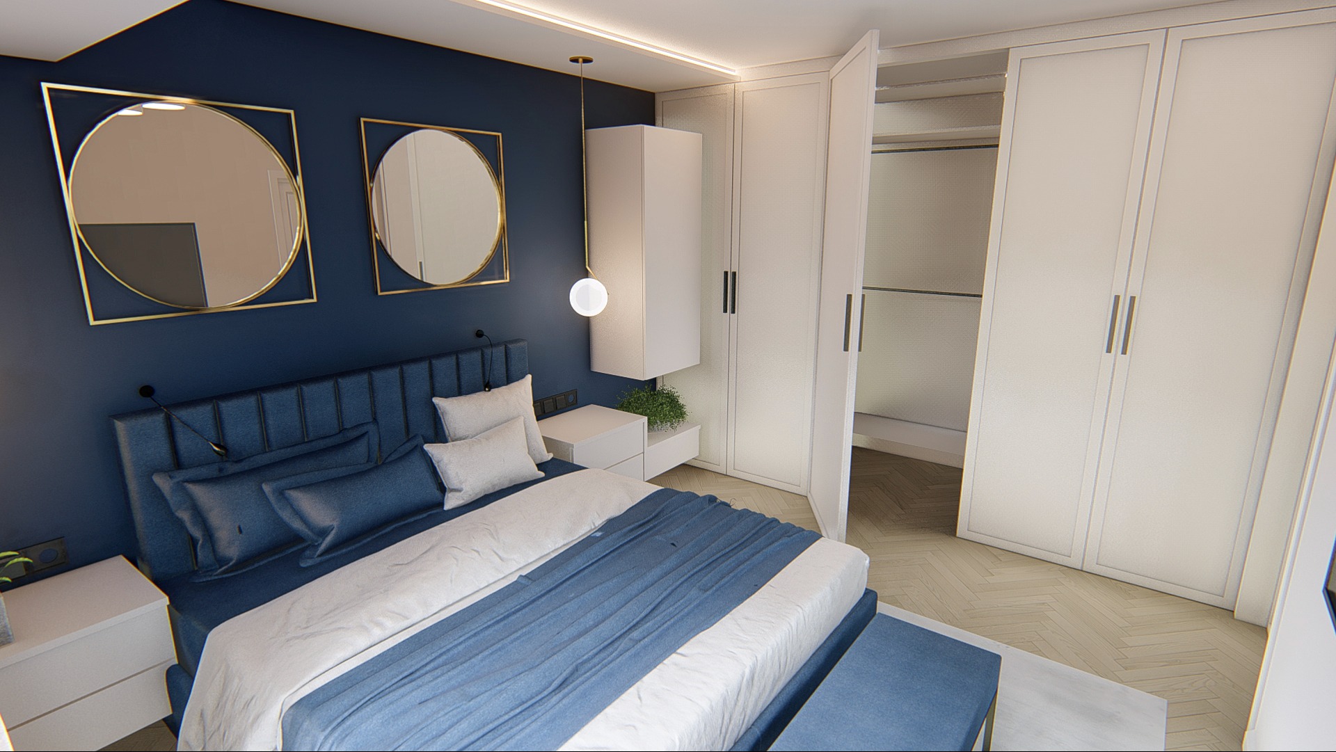 Nowoczesna sypialnia z ciemnoniebieską ścianą, łóżkiem z tapicerowanym zagłówkiem, okrągłymi lustrami w złotych ramach oraz białą zabudową szaf z otwartą przestrzenią garderoby.