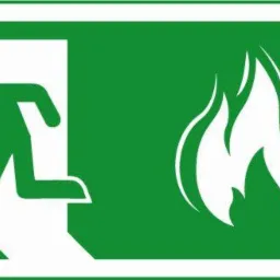 Zielony znak ewakuacyjny z piktogramem biegnącej osoby w kierunku wyjścia oraz symbolem ognia, Ruda Śląska.