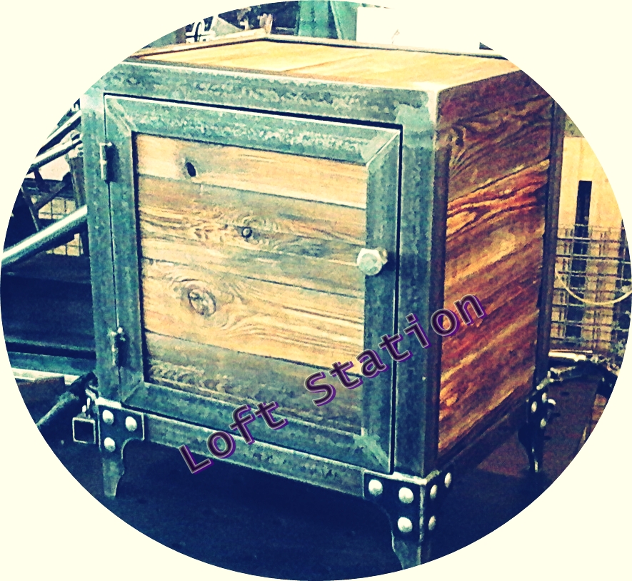 Metalowa szafka nocna w stylu loft z drewnianymi drzwiczkami i dekoracyjnymi nitami na nogach.