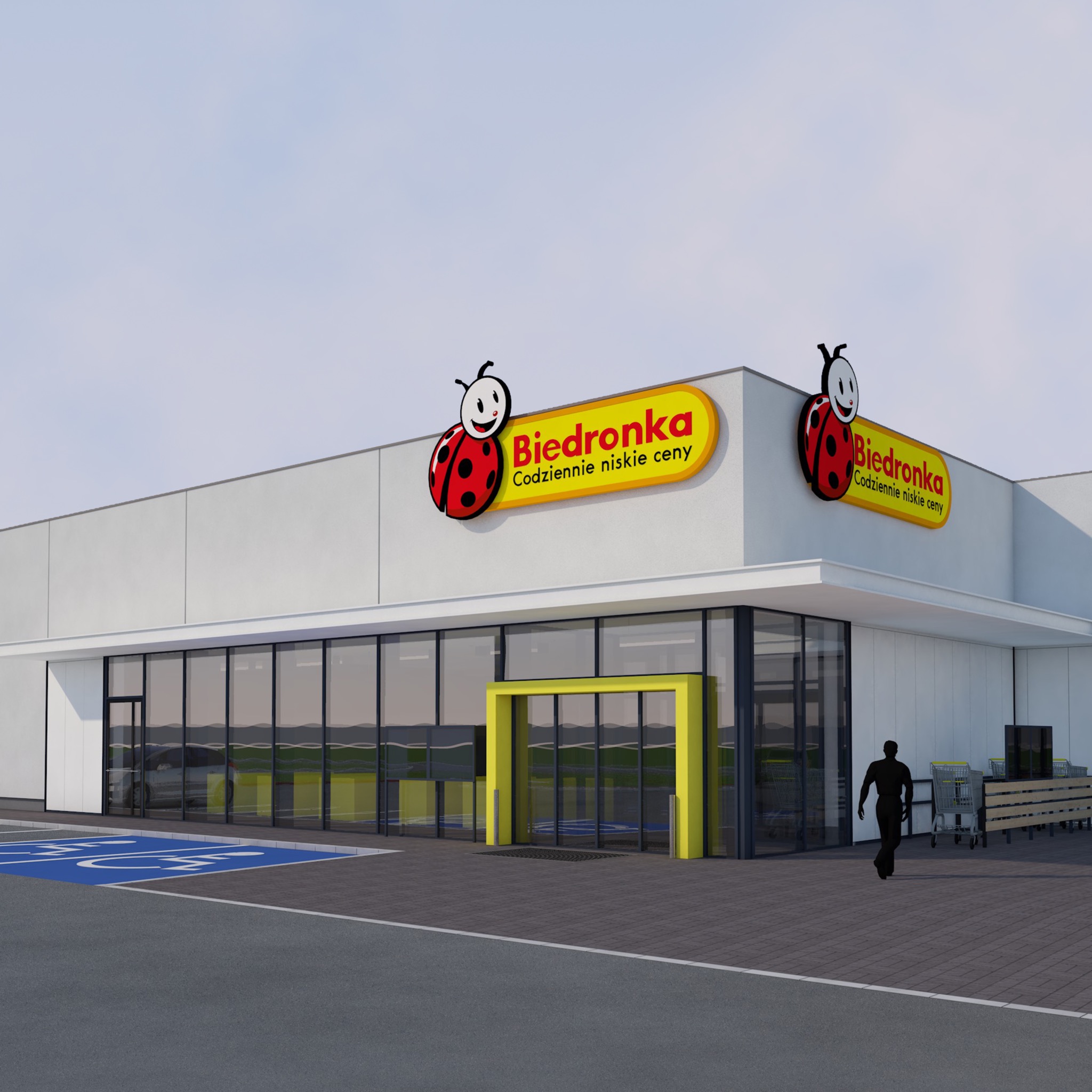 Wizualizacja zewnętrzna budynku usługowego z dużymi oknami, żółtym wejściem i logo Biedronki na elewacji.