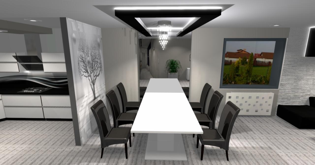 Nowoczesna jadalnia z długim białym stołem, czarnymi krzesłami, dekoracją drzewa na ścianie i widokiem na ogród przez okno.