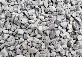 Jasnoszary, drobny żwir o nieregularnych kształtach, wypełniający kadr. Widoczne różnice w odcieniach szarości i fakturze poszczególnych kamieni. Delikatne cienie podkreślają strukturę.