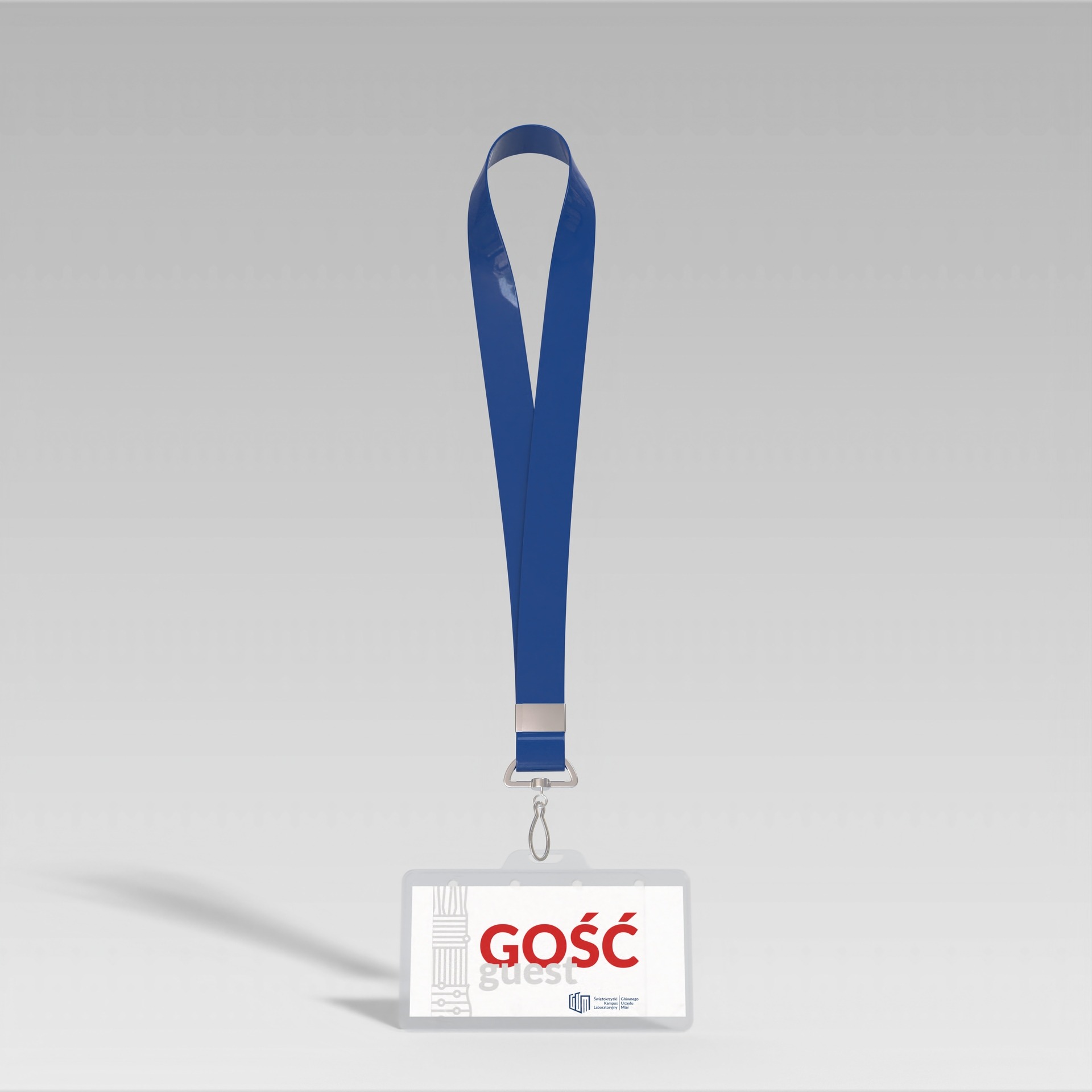 Identyfikator gościa z niebieską smyczą, z czerwonym napisem 'GOŚĆ' i logotypem uczelni w dolnej części, render 3D na szarym tle.
