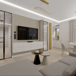 Modei Sztuka & Design - Elegancki salon z szarą sofą, dwoma stolikami kawowymi i telewizorem na panelowej ścianie. Złote lampy, stół jadalniany, aneks kuchenny i szklana ścianka w nowoczesnym wnętrzu.