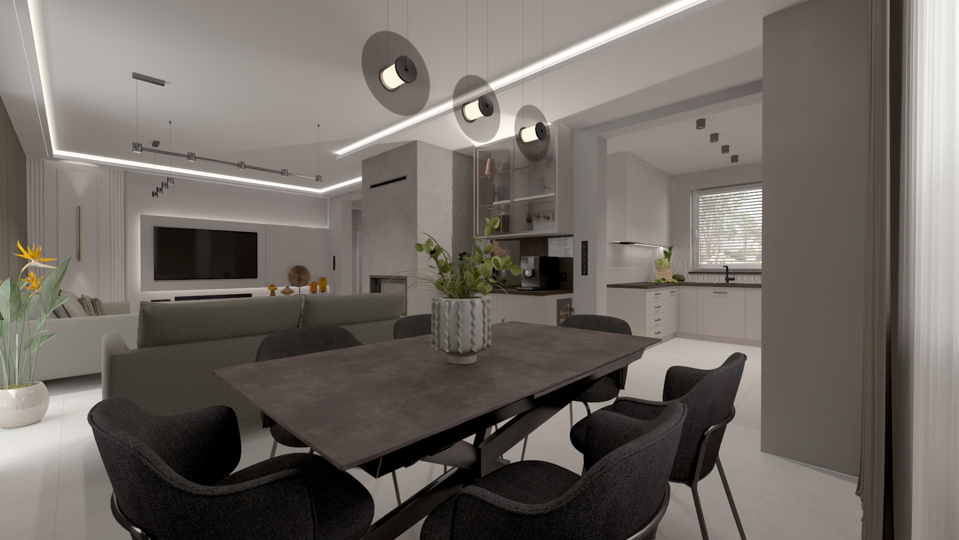 Wnętrze salonu z aneksem kuchennym w odcieniach szarości, z dużym stołem i krzesłami. Nad stołem wiszą trzy okrągłe lampy. W tle telewizor i zabudowa kuchenna.