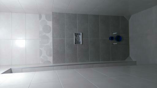 Wykończona łazienka z szarymi i białymi płytkami, wzór z dużymi kołami na jednej ze ścian, widoczne niebieskie elementy instalacji wodnej.