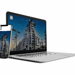 Laptop i smartfon prezentujące responsywną stronę internetową z budynkiem w Gdyni, logo firmy AB Inwestor w lewym górnym rogu ekranów.