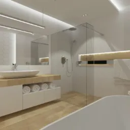 Nowoczesna łazienka z drewnianym blatem pod umywalką, białymi szafkami, lustrem z podświetleniem LED, kabiną prysznicową ze szkła i białymi płytkami heksagonalnymi na ścianie.