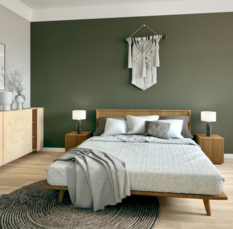 Sypialnia w stylu skandynawskim z drewnianym łóżkiem, szarą narzutą, makramą na ścianie i okrągłym dywanem z wyraźną teksturą.