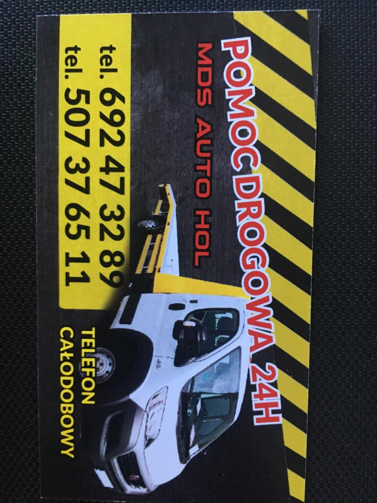 Wizytówka firmy pomocy drogowej z ilustracją białego pojazdu holowniczego, numerami telefonów i napisem 'Pomoc Drogowa 24H'.