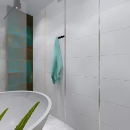 Nowoczesna łazienka z wolnostojącą wanną, czarną armaturą i białymi płytkami z delikatnymi złotymi akcentami, uzupełniona turkusowym ręcznikiem.