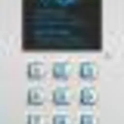 Panel sterowania systemu alarmowego z wyświetlaczem i klawiaturą numeryczną, zamontowany na jasnej ścianie.