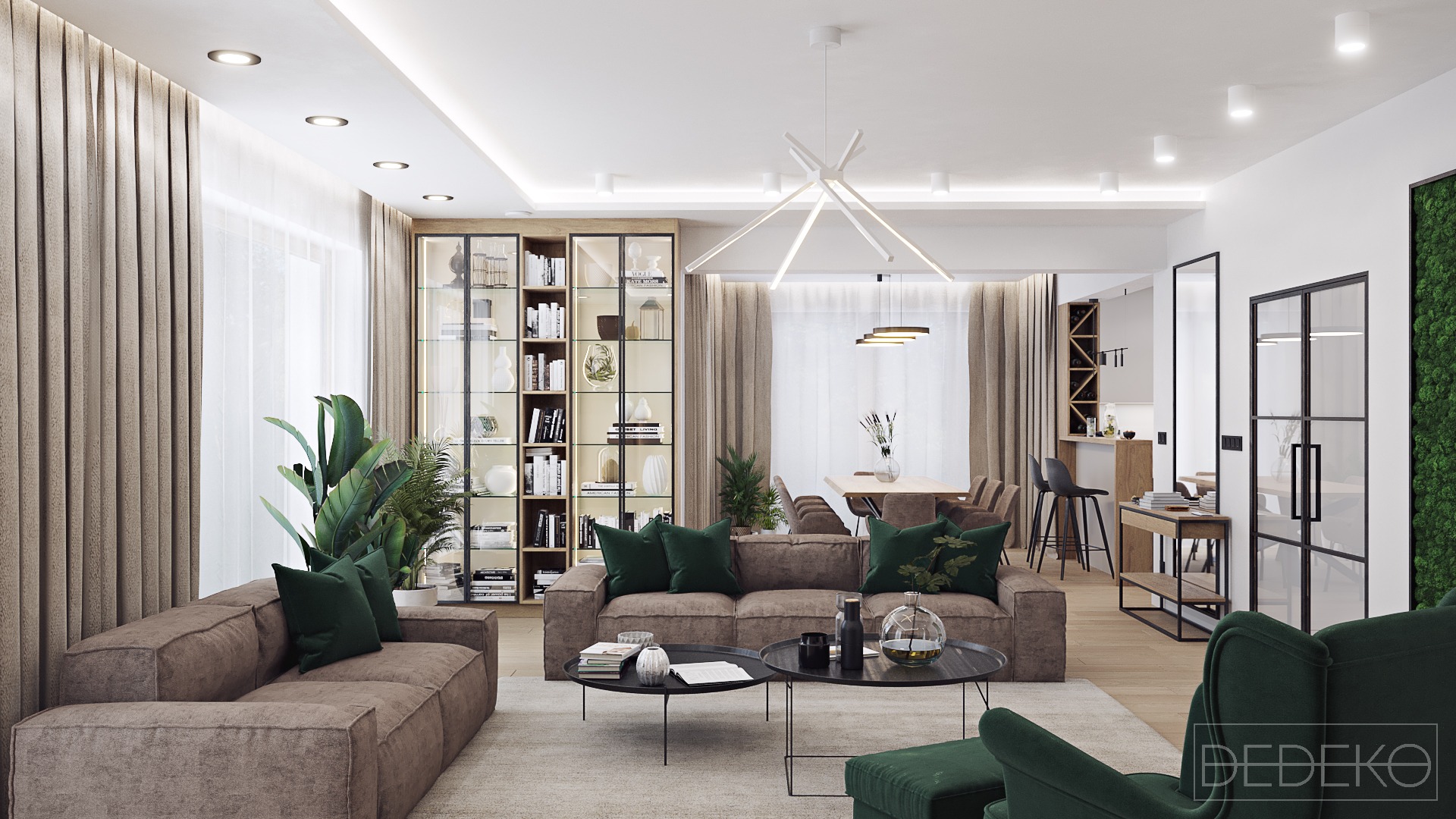 Przestronny salon z brązowymi sofami zdobionymi zielonymi poduszkami, dwie okrągłe kawowe ławy, regał z przeszklonymi drzwiami, jadalnia w tle, ściana z mchu i logo firmy w prawym dolnym rogu.
