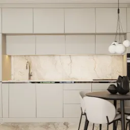 Beżowa kuchnia z marmurowym backsplashiem, okrągłym stołem i designerską lampą wiszącą z białymi kulami