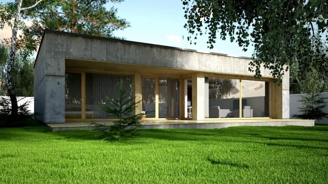 Nowoczesny parterowy dom z betonu architektonicznego i dużymi przeszkleniami, otoczony zielonym trawnikiem i drzewami.