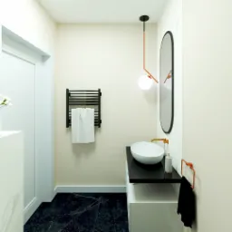 Nowoczesna łazienka z czarnym marmurem na podłodze, owalną umywalką na czarnym blacie, podświetlanym lustrem i grzejnikiem drabinkowym z białym ręcznikiem.