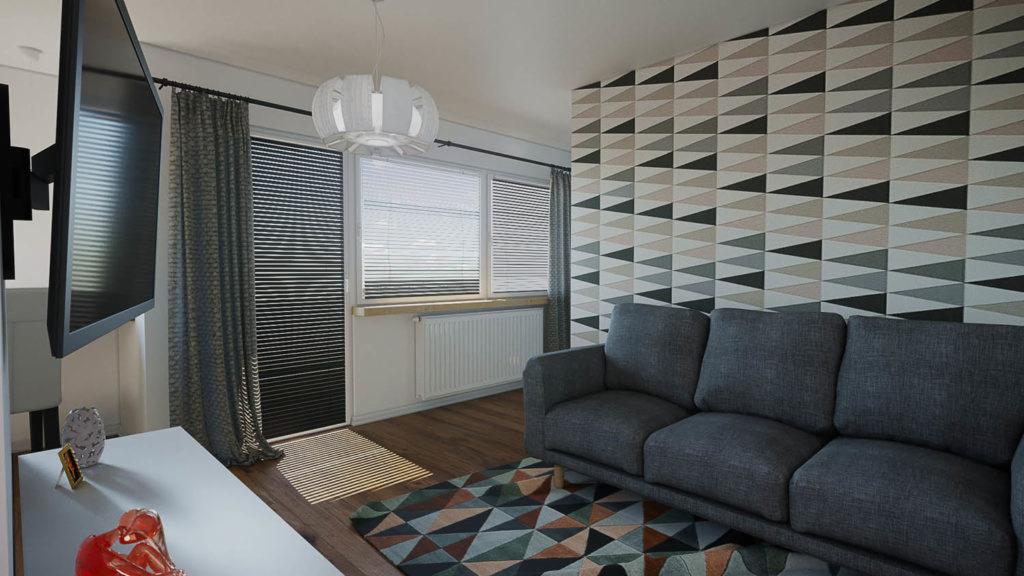 Wnętrze kawalerki z szarą sofą na tle ściany w geometryczne wzory, biały grzejnik pod oknem z żaluzjami, dywan w trójkąty i wisząca lampa nad sofą.