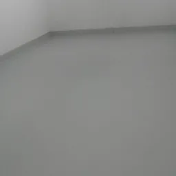 Gładka, szara posadzka jastrychowa w jasnym pomieszczeniu z białymi, częściowo widocznymi ścianami z cegieł.