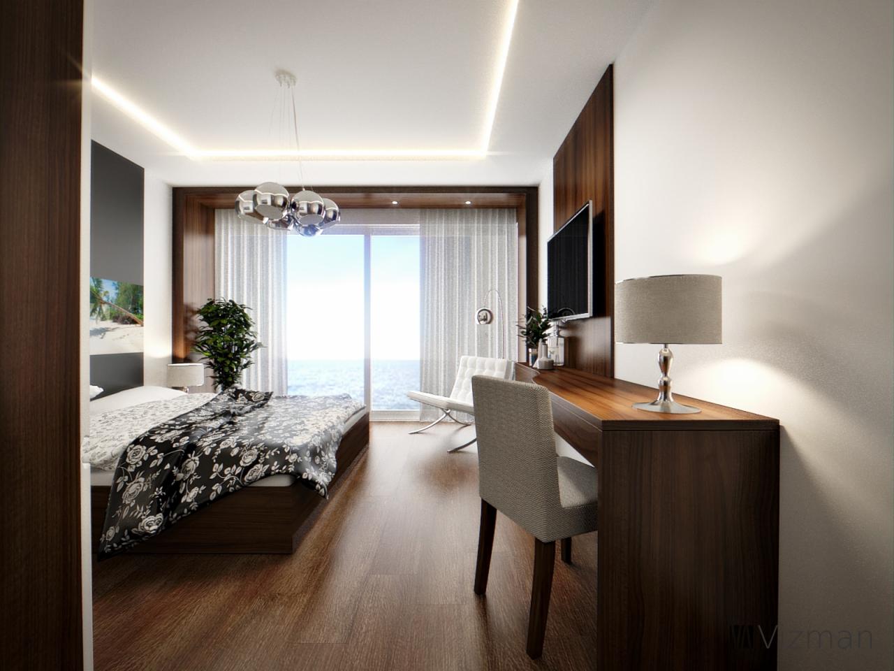 Nowoczesna sypialnia z widokiem na morze, drewniana podłoga, łóżko z czarno-białą pościelą w kwiaty, biurko z lampką i szarym krzesłem, designerska lampa sufitowa.