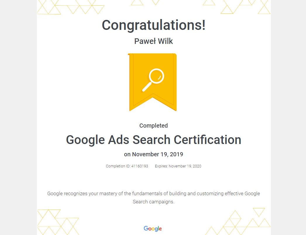 Certyfikat Google Ads Search Certification dla Pawła Wilka z datą ukończenia 19 listopada 2019, z żółtą ikoną lupy na wstążce.